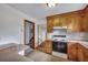 Functional kitchen with wood cabinets and a staircase nearby for convenient access at 7659 Allwood Ave, North Charleston, SC 29418