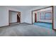 Carpeted living room with doorways and staircase at 7659 Allwood Ave, North Charleston, SC 29418