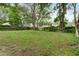 Spacious grassy backyard surrounded by mature trees, shrubbery, and wood fencing at 10 Teaneck Rd, Goose Creek, SC 29445