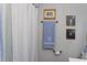Well-appointed bathroom with a blue towel, and coordinated artwork at 10 Teaneck Rd, Goose Creek, SC 29445