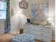 Well-lit bedroom with a white dresser, unique artwork, and comfortable seating at 10 Teaneck Rd, Goose Creek, SC 29445