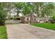 Brick house features a well-manicured lawn and a long driveway at 10 Teaneck Rd, Goose Creek, SC 29445