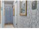 Hallway with elegant wallpaper, framed artwork, and blue painted doors at 10 Teaneck Rd, Goose Creek, SC 29445