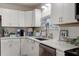 Bright kitchen with white cabinets, stainless steel appliances, and attractive backsplash at 10 Teaneck Rd, Goose Creek, SC 29445