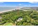 Stunning aerial view of the property surrounded by lush greenery and situated near the beautiful oceanfront at 1025 Scaup Ct, Kiawah Island, SC 29455