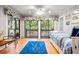 Bright bedroom features wood floors, decorative windows, and access to the outdoor porch at 1025 Scaup Ct, Kiawah Island, SC 29455