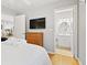 Bedroom featuring a TV and dresser, with an adjacent view into the bathroom at 1025 Scaup Ct, Kiawah Island, SC 29455