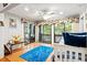 Bright bedroom features wood floors, decorative windows, and access to the outdoor porch at 1025 Scaup Ct, Kiawah Island, SC 29455