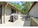 Spacious wooden deck with outdoor dining set and grill, surrounded by lush trees at 1025 Scaup Ct, Kiawah Island, SC 29455