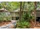 Charming raised home with beautiful green surroundings, a convenient drive-through carport, and a cozy porch at 1025 Scaup Ct, Kiawah Island, SC 29455