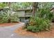 Charming elevated home with beautiful landscaping, a convenient drive-through carport, and a cozy front porch at 1025 Scaup Ct, Kiawah Island, SC 29455