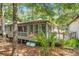 Charming home exterior with a screened porch, inviting deck, and lush surrounding trees at 1025 Scaup Ct, Kiawah Island, SC 29455