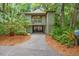 Charming home featuring a drive-through carport, lush landscaping, and a welcoming front porch at 1025 Scaup Ct, Kiawah Island, SC 29455