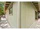 Close-up of corner of house showing wood paneling, window, and the outdoor deck at 1025 Scaup Ct, Kiawah Island, SC 29455