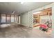 View of the unfinished garage space with bike trailer and other household storage items, ideal for organization at 1025 Scaup Ct, Kiawah Island, SC 29455
