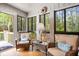 Relaxing sunroom with wicker seating, natural light, and scenic outdoor views at 1025 Scaup Ct, Kiawah Island, SC 29455