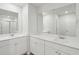 Bathroom features dual sinks, white cabinets, large mirrors, and wood-look flooring at 108 Lefton Lndg, Summerville, SC 29485