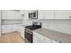 Modern kitchen features granite countertops, stainless appliances, and white cabinets at 108 Lefton Lndg, Summerville, SC 29485