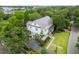 Aerial view of a two-story home with a metal roof surrounded by trees and lush landscaping at 108 Live Oak Dr, Mount Pleasant, SC 29464