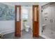 Bright bathroom showcasing a toilet room, walk-in shower with white marble and glass door, plus natural light at 108 Live Oak Dr, Mount Pleasant, SC 29464