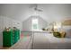 Bright bedroom with two twin beds, green accents, hardwood floors, and an attic-style ceiling with window at 108 Live Oak Dr, Mount Pleasant, SC 29464
