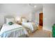 Cozy bedroom featuring two twin beds with matching decor, white walls, and a decorative woven headboard at 108 Live Oak Dr, Mount Pleasant, SC 29464