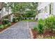 Gravel driveway with brick accents and lush landscaping leading up to a charming home at 108 Live Oak Dr, Mount Pleasant, SC 29464
