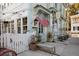 Charming storefront with an American flag, outdoor seating, and a white picket fence at 108 Live Oak Dr, Mount Pleasant, SC 29464