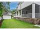 Home exterior with a screened porch, white siding, and lush green lawn at 108 Live Oak Dr, Mount Pleasant, SC 29464