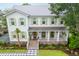 Charming two-story home with a metal roof, covered porch and elegant landscaping at 108 Live Oak Dr, Mount Pleasant, SC 29464