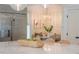 Close-up of a kitchen island with marble countertop, adjacent to a breakfast nook with seating and stainless steel refrigerator at 108 Live Oak Dr, Mount Pleasant, SC 29464