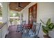 Relaxing outdoor porch with rocking chairs, wood ceiling, and a view of the neighborhood at 108 Live Oak Dr, Mount Pleasant, SC 29464