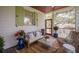 Inviting screened-in porch with comfortable seating, stylish decor, and views of the surrounding landscape at 108 Live Oak Dr, Mount Pleasant, SC 29464