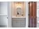 Elegant powder room with custom vanity, attractive lighting, and neutral decor at 108 Live Oak Dr, Mount Pleasant, SC 29464