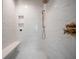 Modern shower boasts marble tile, built-in shelving, a comfortable bench, and sleek fixtures for a spa-like experience at 108 Live Oak Dr, Mount Pleasant, SC 29464