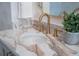 Close up on a powder room vanity featuring a marble countertop and sink with gold faucet and neutral wall paper at 108 Live Oak Dr, Mount Pleasant, SC 29464