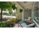 Relaxing front porch area featuring comfortable seating and views of the landscaped front yard at 108 Plume Poppy Ln, Ladson, SC 29456