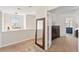 Upstairs hallway featuring carpet floors, a large mirror, and views to a bedroom and dining space at 108 Plume Poppy Ln, Ladson, SC 29456