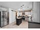 Spacious kitchen featuring stainless steel appliances, light gray cabinets, an island, and a sliding barn door at 108 Plume Poppy Ln, Ladson, SC 29456