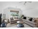 Bright living room with neutral tones, including sofa set, and patterned rug at 108 Plume Poppy Ln, Ladson, SC 29456