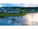 Community clubhouse with lake view featuring a pool, covered seating, and a tranquil water setting at 113 Magnolia House Dr, Summerville, SC 29486