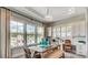 Dining area featuring large windows, a stylish table and chairs set, along with built-in cabinets and desk space at 113 Magnolia House Dr, Summerville, SC 29486