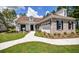 Charming single-story home featuring manicured lawn, a walkway and a mix of brick and siding exterior elements at 113 Magnolia House Dr, Summerville, SC 29486