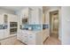 Well-lit kitchen featuring white cabinetry, stainless steel microwave and oven, and blue tiled backsplash at 113 Magnolia House Dr, Summerville, SC 29486