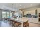 Bright kitchen featuring large island with seating, pendant lights, stainless appliances, and adjacent dining area at 113 Magnolia House Dr, Summerville, SC 29486