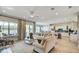 Bright living room featuring neutral paint, hardwood floors, a ceiling fan, with an open view to the kitchen at 113 Magnolia House Dr, Summerville, SC 29486