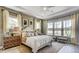 Bedroom with a king size bed, lots of windows and natural light and great views of the surrounding landscape at 113 Magnolia House Dr, Summerville, SC 29486