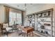 Inviting home office with wood desk, bookshelves, and a comfortable chair, bathed in natural light at 113 Magnolia House Dr, Summerville, SC 29486