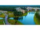 Aerial view of neighborhood by the lake with well-maintained lawns and tree lined streets at 120 Magnolia House Dr, Summerville, SC 29486