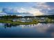 Aerial view of community clubhouse, lake, and surrounding landscape under a blue sky at 120 Magnolia House Dr, Summerville, SC 29486